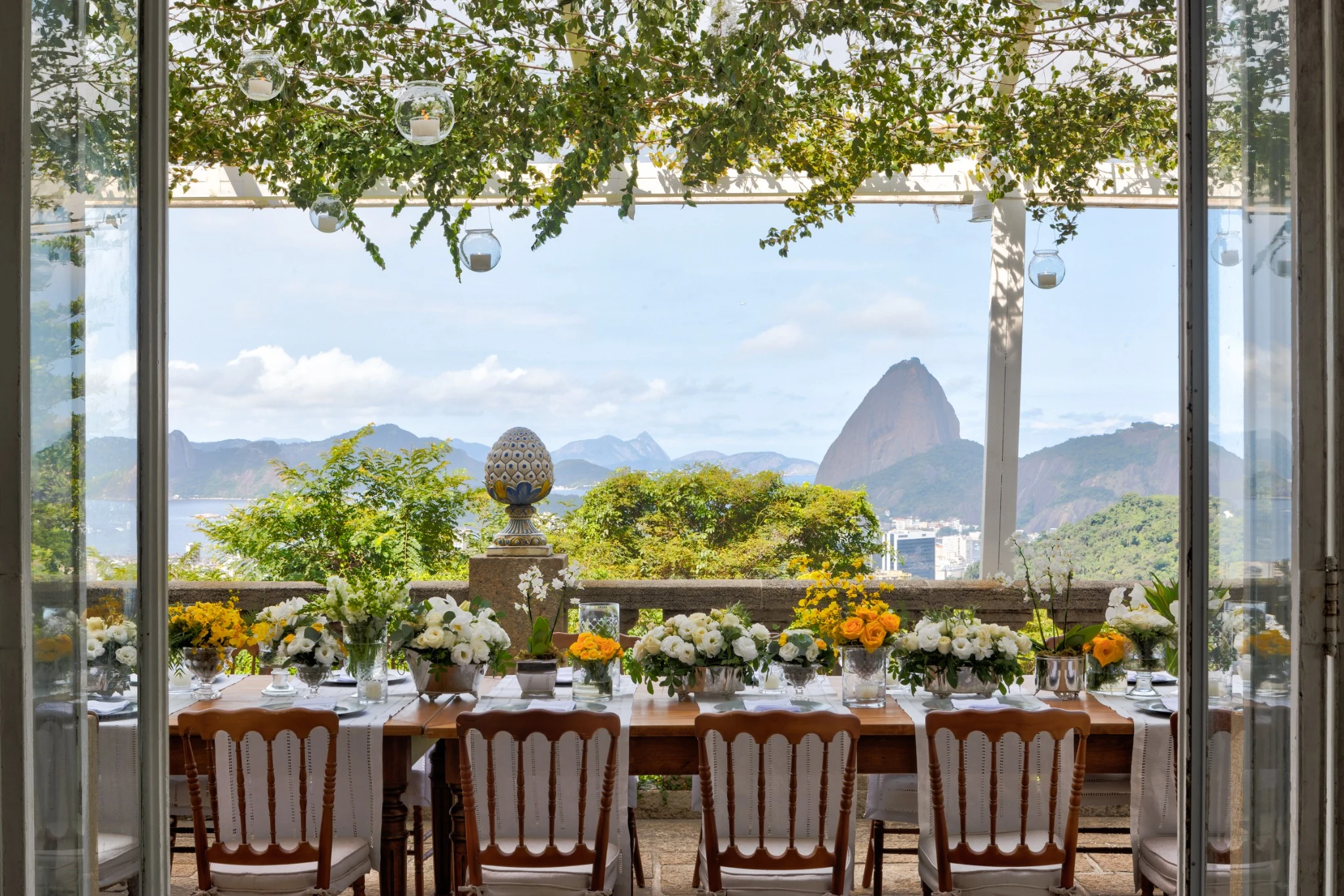 Decorated dining table with flowers and a view of Sugarloaf Mountain.