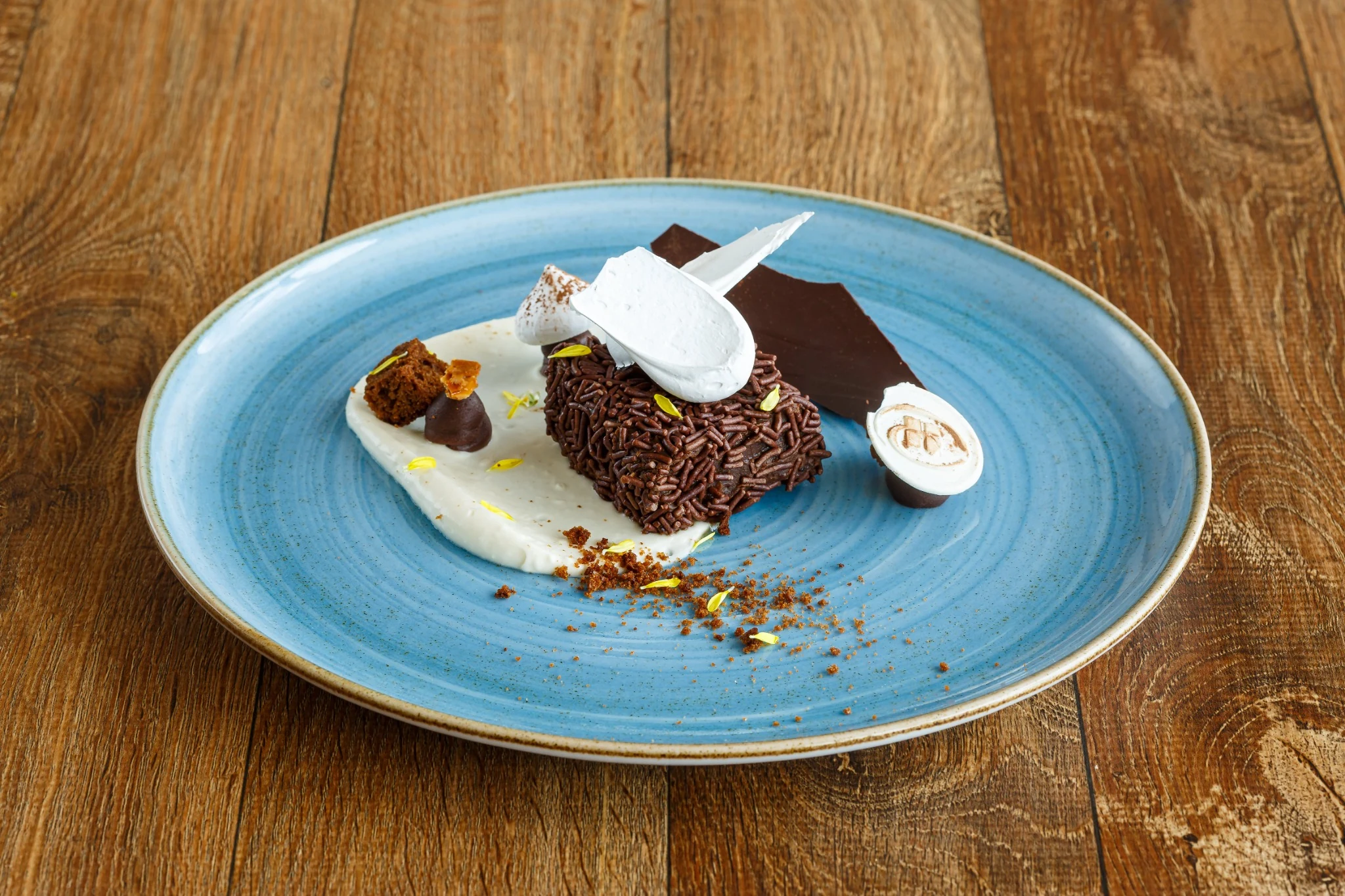 Dessert plated on a blue dish on a wooden table.