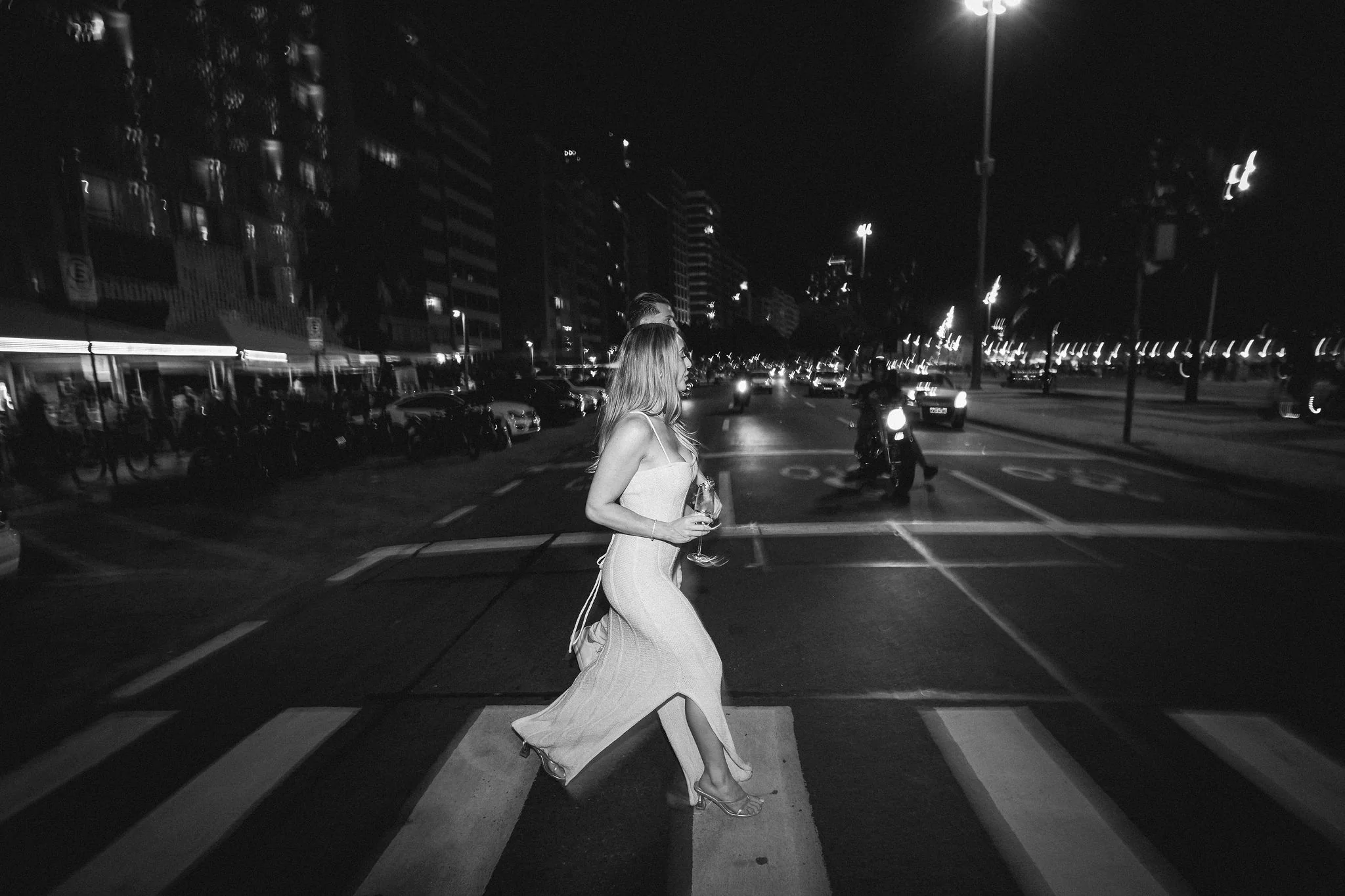 Black and white photograph of Kourtney walking across a street in Rio de Janeiro.