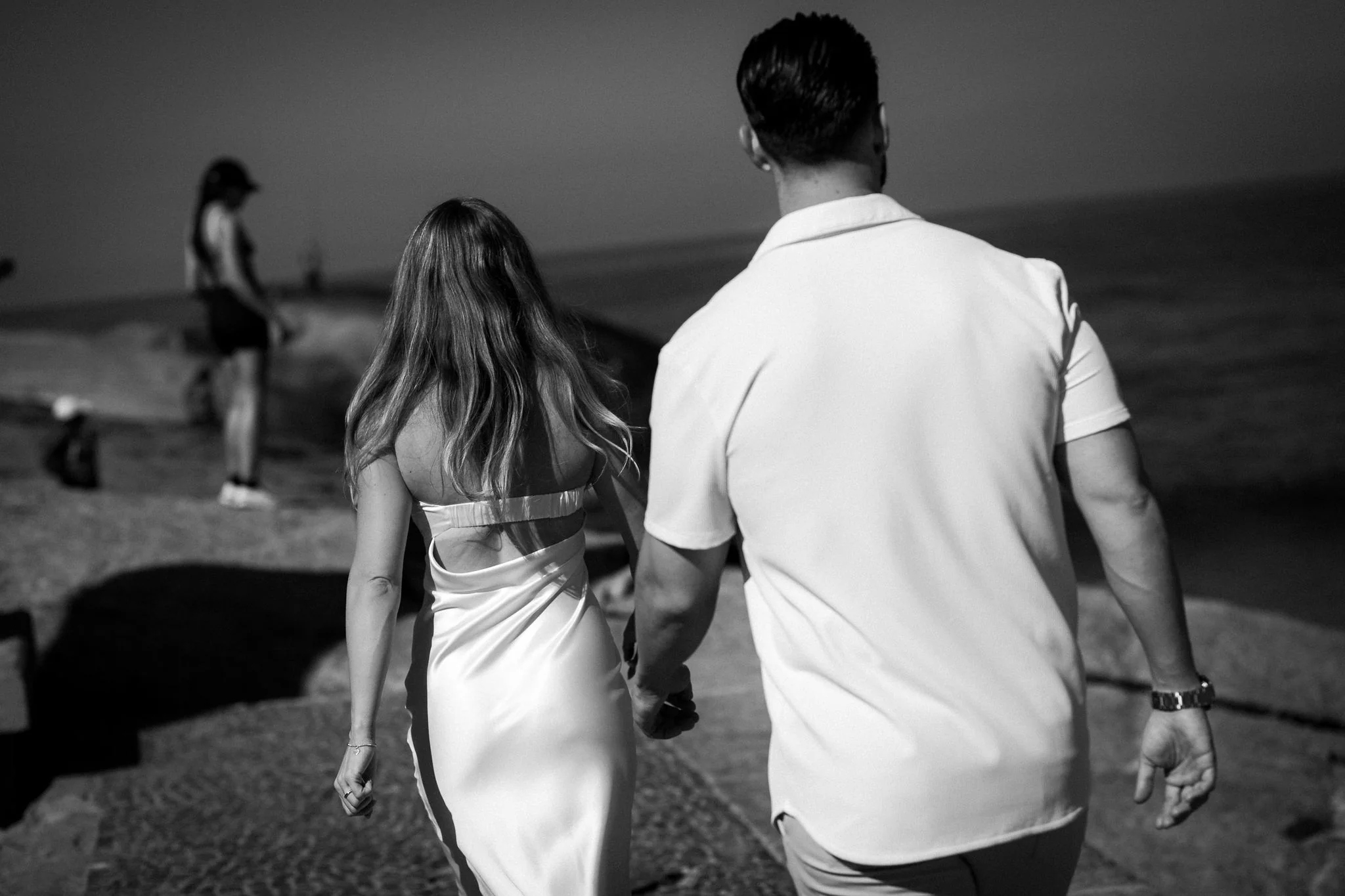 Kourtney and Chris walking together at Arpoador beach in Rio de Janeiro.